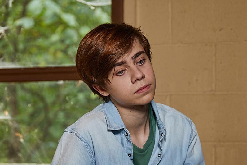teen boy looking sad